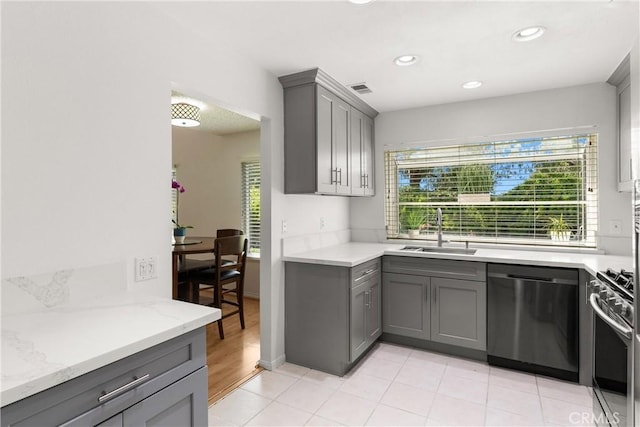 12746 Rosebrook Way, Stanton, CA 90680 - kitchen featuring stainless steel appliances, gray cabinetry, healthy amount of natural light, light stone countertops, and recessed lighting
