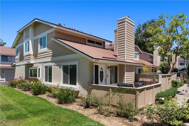 12746 Rosebrook Way, Stanton, CA 90680 - rear view of house with a chimney and a lawn