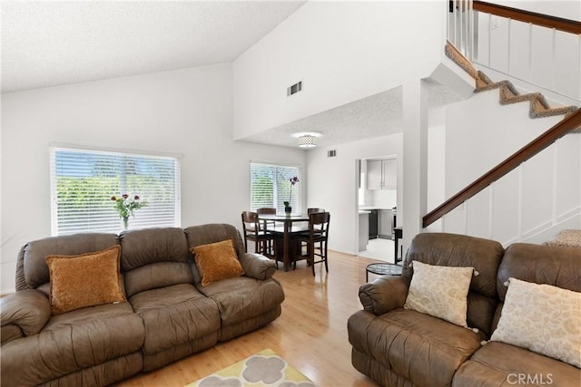 12746 Rosebrook Way, Stanton, CA 90680 - living area featuring stairs, high vaulted ceiling, and light wood-type flooring