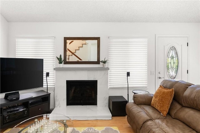 12746 Rosebrook Way, Stanton, CA 90680 - living room with a textured ceiling, wood finished floors, and a premium fireplace