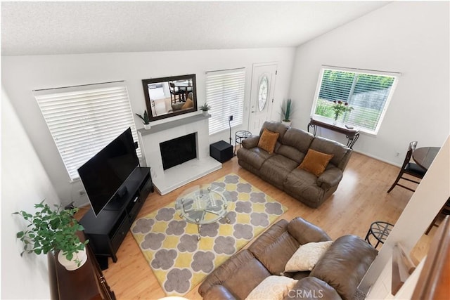 12746 Rosebrook Way, Stanton, CA 90680 - living room featuring lofted ceiling, wood finished floors, and a fireplace with raised hearth