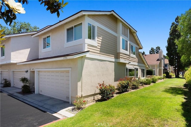 12746 Rosebrook Way, Stanton, CA 90680 - view of side of home with stucco siding, a yard, and a garage