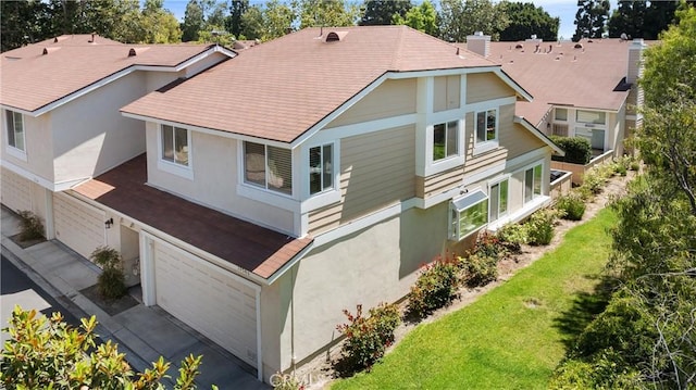 12746 Rosebrook Way, Stanton, CA 90680 - back of property with a garage, stucco siding, a lawn, and a shingled roof