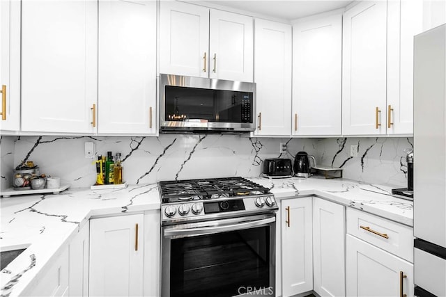 456 E San Jose Ave Unit C, Burbank, CA 91501 - kitchen with stainless steel appliances, white cabinets, decorative backsplash, and light stone countertops