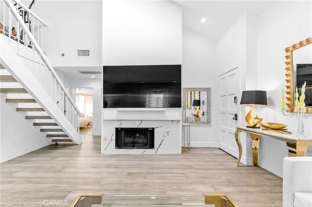 456 E San Jose Ave Unit C, Burbank, CA 91501 - living area with high vaulted ceiling, stairway, wood finished floors, a fireplace, and recessed lighting