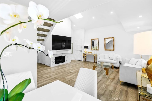 456 E San Jose Ave Unit C, Burbank, CA 91501 - living room with wood finished floors, recessed lighting, lofted ceiling, a skylight, and a high end fireplace