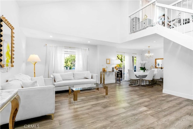 456 E San Jose Ave Unit C, Burbank, CA 91501 - living area featuring healthy amount of natural light, wood finished floors, a chandelier, recessed lighting, and a high ceiling