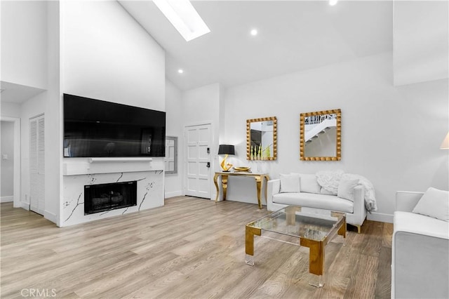 456 E San Jose Ave Unit C, Burbank, CA 91501 - living room with high vaulted ceiling, a skylight, wood finished floors, recessed lighting, and a premium fireplace