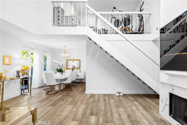 456 E San Jose Ave Unit C, Burbank, CA 91501 - living room with stairway, wood finished floors, a chandelier, and a towering ceiling