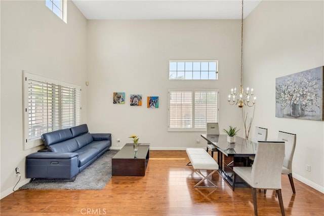 870 E Bermuda Dunes Ct, Ontario, CA 91761 - living area with a towering ceiling, a chandelier, plenty of natural light, and wood finished floors