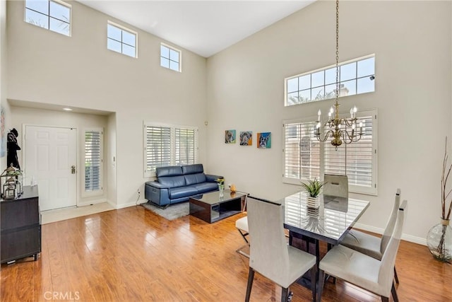 870 E Bermuda Dunes Ct, Ontario, CA 91761 - dining space featuring a high ceiling, a chandelier, wood finished floors, and plenty of natural light