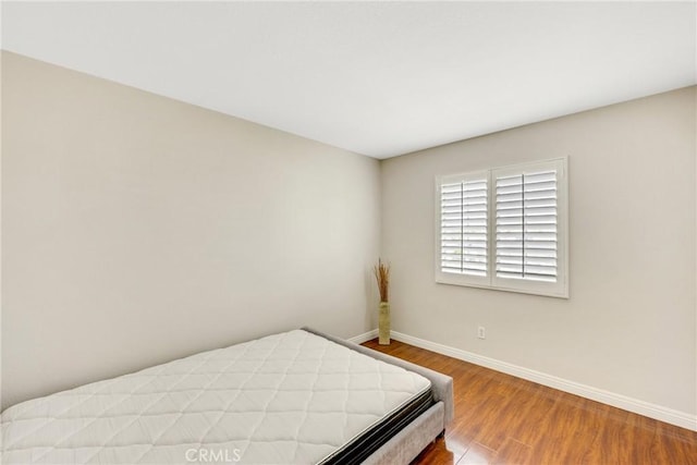 870 E Bermuda Dunes Ct, Ontario, CA 91761 - bedroom with baseboards and wood finished floors