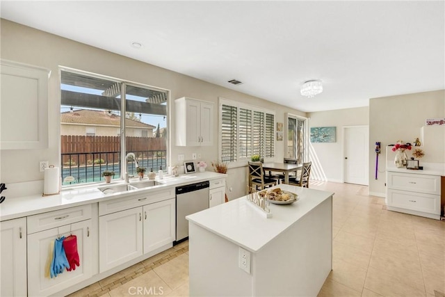 870 E Bermuda Dunes Ct, Ontario, CA 91761 - kitchen featuring stainless steel dishwasher, light tile patterned floors, white cabinetry, light countertops, and a kitchen island