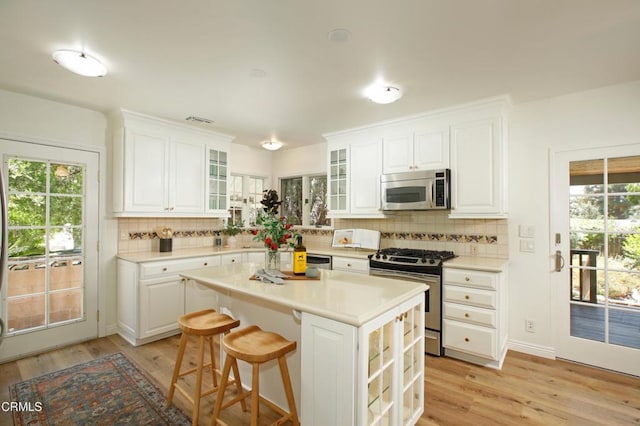 3628 El Caminito Ln, Crescenta, CA 91214 - kitchen with stainless steel appliances, light wood-type flooring, and backsplash