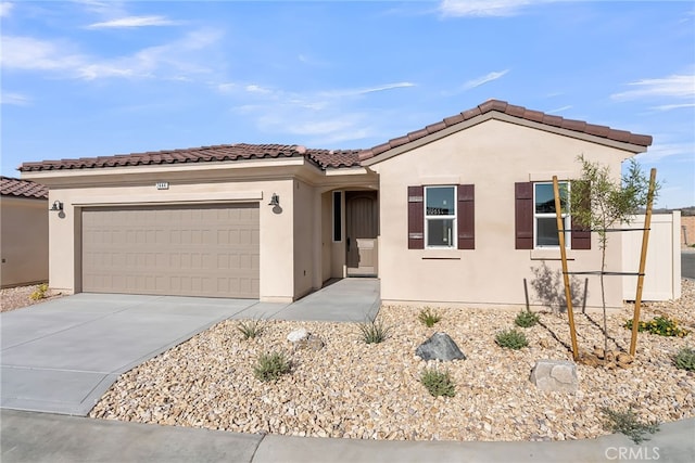 7444 Desert Sky Dr, Yucca Valley, CA 92284 - view of front of house with stucco siding, a garage, concrete driveway, and a tile roof