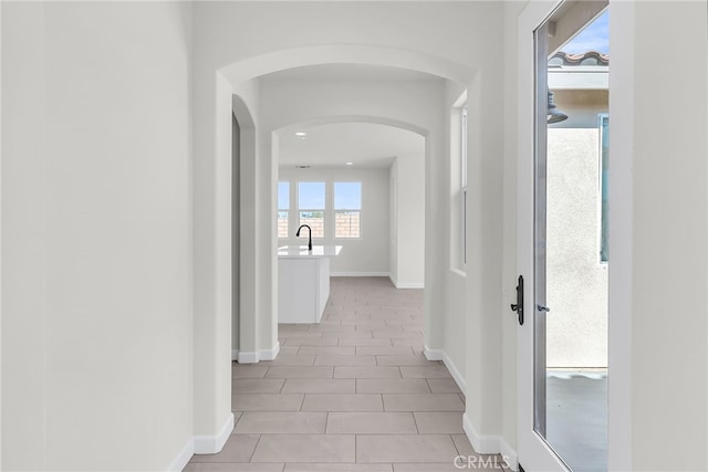 7444 Desert Sky Dr, Yucca Valley, CA 92284 - corridor featuring arched walkways and light tile patterned flooring