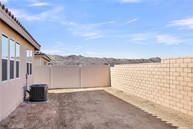7444 Desert Sky Dr, Yucca Valley, CA 92284 - fenced backyard with a mountain view and a patio