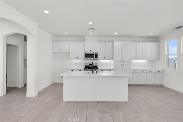 7444 Desert Sky Dr, Yucca Valley, CA 92284 - kitchen with stainless steel microwave, backsplash, light countertops, and recessed lighting