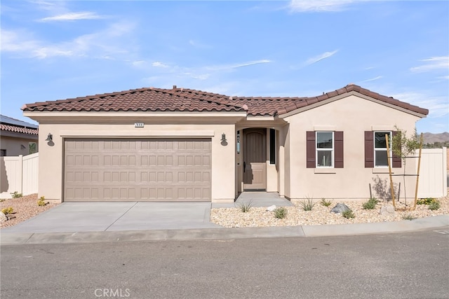 7444 Desert Sky Dr, Yucca Valley, CA 92284 - mediterranean / spanish house with driveway, a garage, stucco siding, and a tile roof