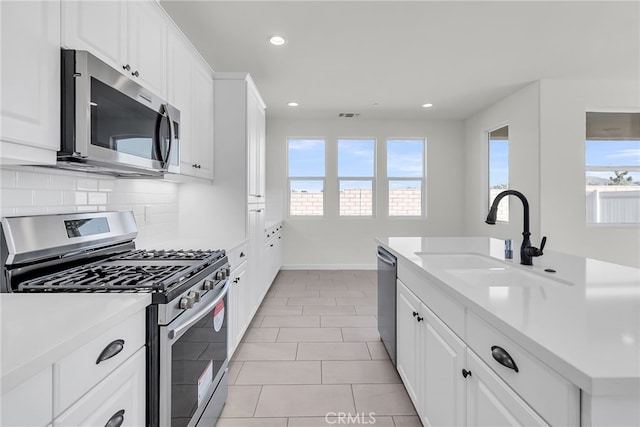7444 Desert Sky Dr, Yucca Valley, CA 92284 - kitchen featuring stainless steel appliances, decorative backsplash, recessed lighting, light countertops, and white cabinetry