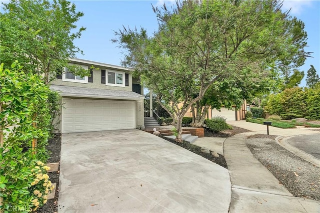 1059 Hillview Cir, Simi Valley, CA 93065 - view of front of house featuring an attached garage, driveway, and stucco siding