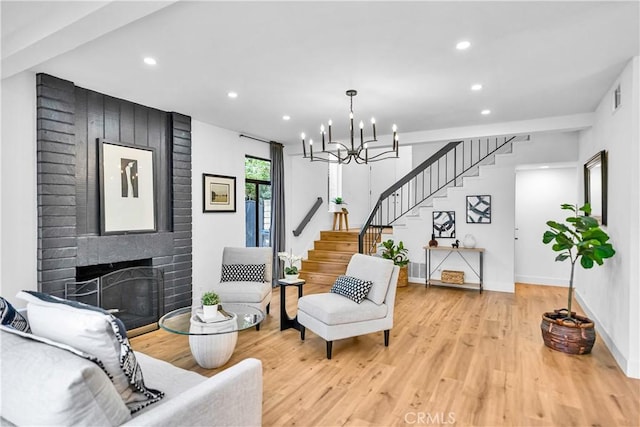 1059 Hillview Cir, Simi Valley, CA 93065 - living room with stairway, a chandelier, light wood finished floors, recessed lighting, and a fireplace