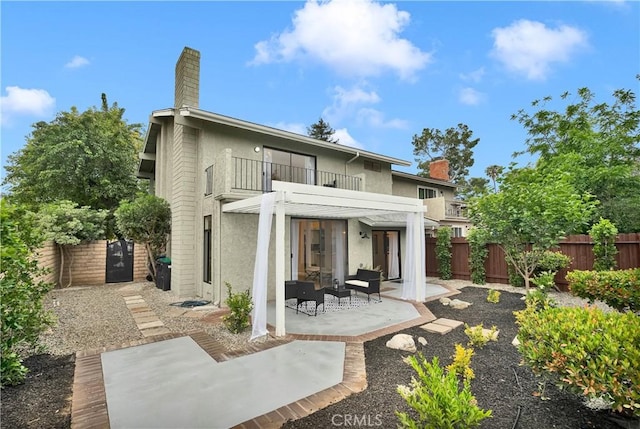1059 Hillview Cir, Simi Valley, CA 93065 - back of house featuring a balcony, a chimney, stucco siding, and a patio area
