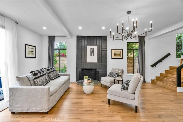 1059 Hillview Cir, Simi Valley, CA 93065 - living room featuring light wood-type flooring, a chandelier, recessed lighting, stairway, and a brick fireplace