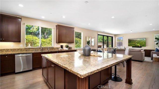103 Sabiosa, Irvine, CA 92618 - kitchen with dishwasher, a kitchen island, light stone countertops, light wood-type flooring, and recessed lighting