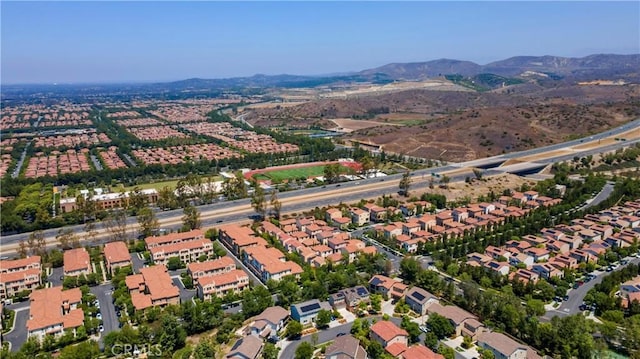 103 Sabiosa, Irvine, CA 92618 - aerial overview of property's location with nearby suburban area and a mountain backdrop