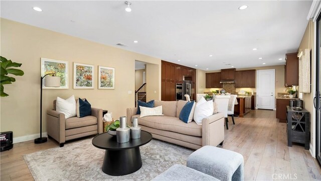 103 Sabiosa, Irvine, CA 92618 - living room featuring recessed lighting, light wood-style flooring, and stairs