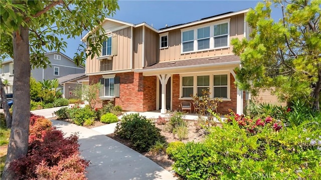 103 Sabiosa, Irvine, CA 92618 - traditional-style home featuring brick siding, board and batten siding, and covered porch