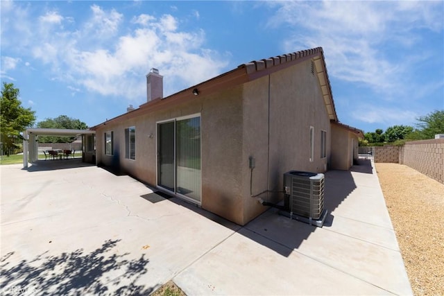 13161 Mugu Ct, Apple Valley, CA 92308 - back of property with a patio area, stucco siding, and a chimney