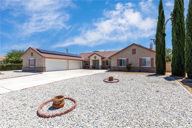13161 Mugu Ct, Apple Valley, CA 92308 - ranch-style home featuring stucco siding, solar panels, an attached garage, and concrete driveway