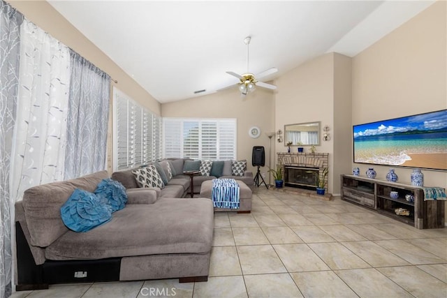 13161 Mugu Ct, Apple Valley, CA 92308 - living room featuring lofted ceiling, a ceiling fan, light tile patterned floors, and a fireplace