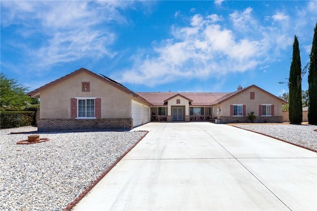 13161 Mugu Ct, Apple Valley, CA 92308 - ranch-style house featuring concrete driveway, stucco siding, an attached garage, and brick siding