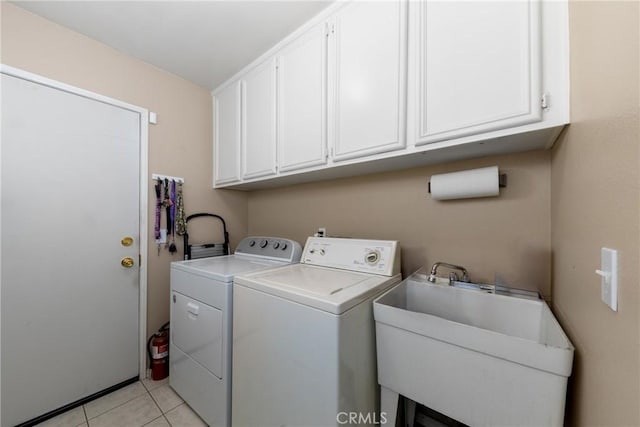 13161 Mugu Ct, Apple Valley, CA 92308 - washroom with washer and dryer, cabinet space, and light tile patterned flooring