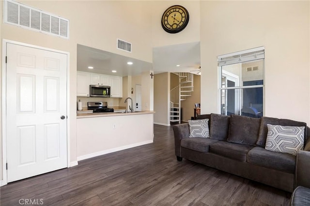 20000 Plum Canyon Rd Unit 1827, Saugus, CA 91350 - living area with dark wood-type flooring, a high ceiling, stairs, ceiling fan, and recessed lighting