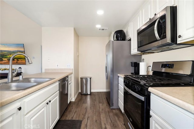 20000 Plum Canyon Rd Unit 1827, Saugus, CA 91350 - kitchen with appliances with stainless steel finishes, white cabinets, dark wood-style floors, light countertops, and recessed lighting