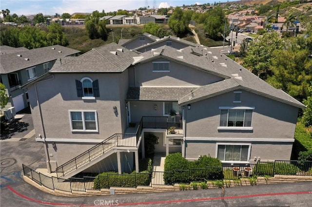 20000 Plum Canyon Rd Unit 1827, Saugus, CA 91350 - view of front of property featuring stucco siding, a fenced front yard, and stairway