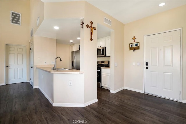20000 Plum Canyon Rd Unit 1827, Saugus, CA 91350 - kitchen featuring appliances with stainless steel finishes, dark wood-type flooring, white cabinets, a peninsula, and recessed lighting