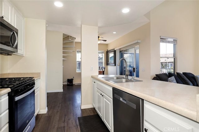 20000 Plum Canyon Rd Unit 1827, Saugus, CA 91350 - kitchen featuring appliances with stainless steel finishes, light countertops, dark wood-style floors, a ceiling fan, and white cabinetry