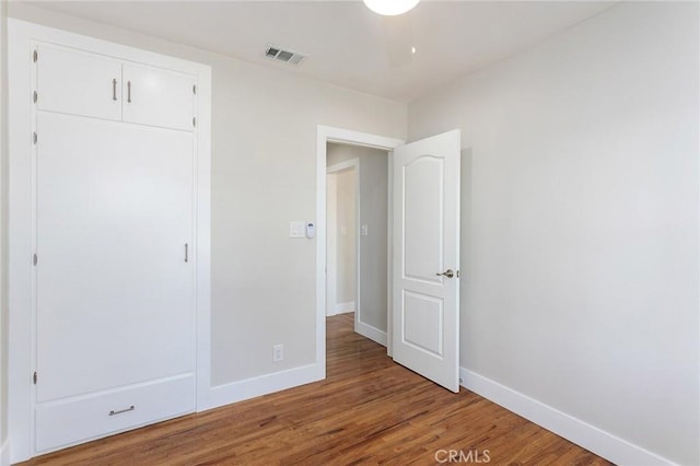783 E Grand Ave, Pomona, CA 91766 - unfurnished bedroom featuring wood finished floors and a closet