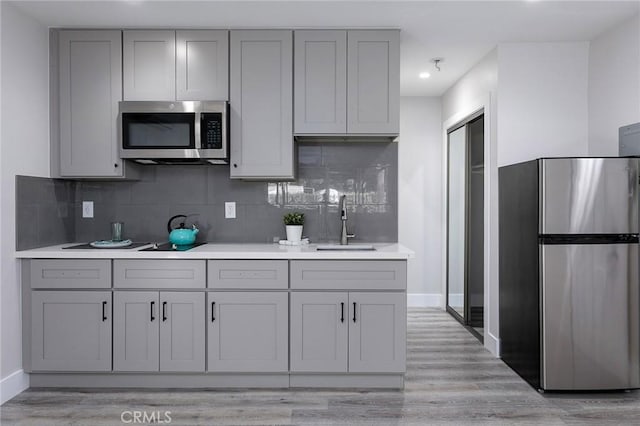 783 E Grand Ave, Pomona, CA 91766 - kitchen with appliances with stainless steel finishes, gray cabinetry, decorative backsplash, and recessed lighting