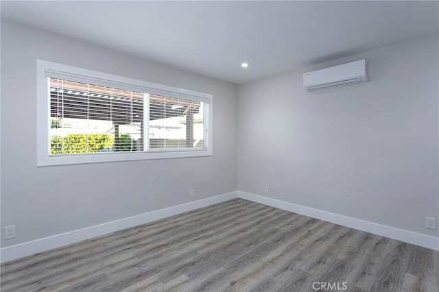 783 E Grand Ave, Pomona, CA 91766 - unfurnished room with a wall mounted air conditioner, wood finished floors, and recessed lighting