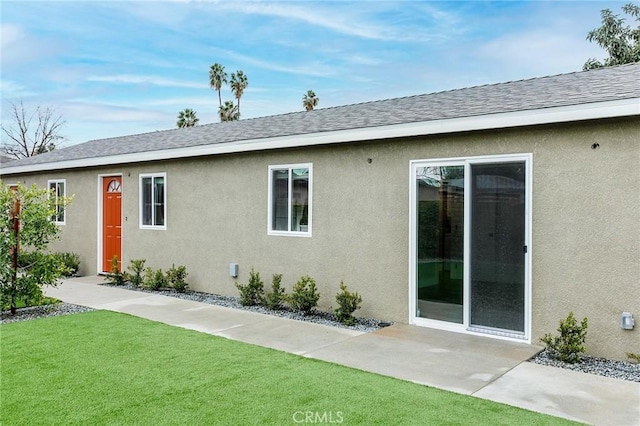 783 E Grand Ave, Pomona, CA 91766 - rear view of house with a lawn, stucco siding, and a shingled roof