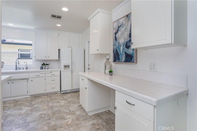 15713 Tuba St, North Hills, CA 91343 - kitchen featuring white refrigerator with ice dispenser, white cabinetry, recessed lighting, and tile counters