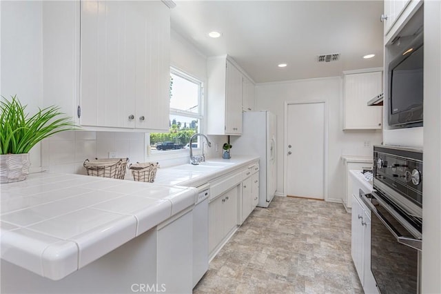 15713 Tuba St, North Hills, CA 91343 - kitchen with tile countertops, white cabinets, white appliances, backsplash, and recessed lighting