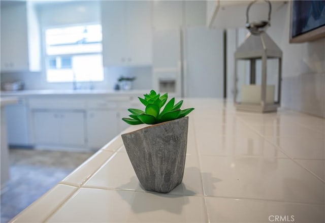 15713 Tuba St, North Hills, CA 91343 - kitchen featuring white fridge with ice dispenser, light countertops, and white cabinetry