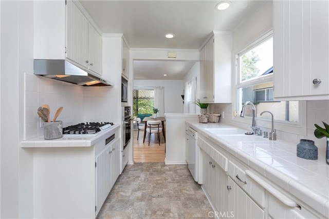 15713 Tuba St, North Hills, CA 91343 - kitchen featuring under cabinet range hood, tasteful backsplash, tile counters, white cabinets, and recessed lighting
